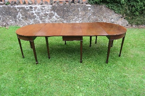 A Regency design mahogany extending D end dining table, comprising two D ends and central gate leg