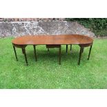 A Regency design mahogany extending D end dining table, comprising two D ends and central gate leg