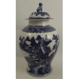 A Qinlong style covered vase, decorated in blues within an all around landscape with buildings and