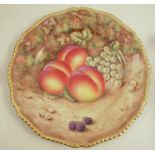 A Royal Worcester plate, decorated with hand painted fruit by Love, to a gadrooned border,