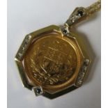 A 2002 half sovereign in a 9 carat gold mount formed as a pendant, with black diamonds, together