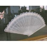 A cased 21 spine leaf pierced ivory fan, width 11ins