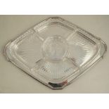 A silver and glass hors d'oeuvers dish, the silver tray with shaped edge having five glass dishes,