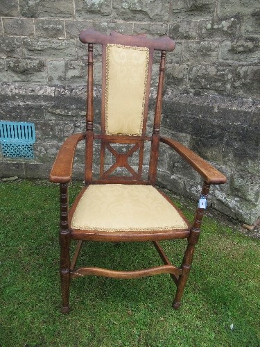 An Arts and Crafts high backed open armchair
