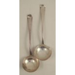 A pair of mid 18th century silver sauce ladles, engraved with a crest, bottom marked, London circa