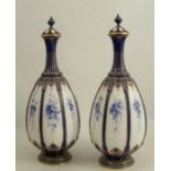 A pair of Royal Worcester covered vases, decorated with panels of blue flowers, shape number 1824,