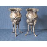 A pair of hallmarked silver vases, raised on three lions mask and hoof feet, approximately 10oz