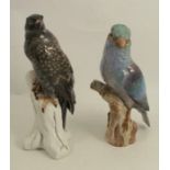 A continental model, of a bird of prey on a stump, together with a continental model of another