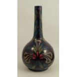 A Morris ware bottle vase, decorated with stylised flowers by George Cartlidge, height 11.