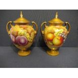 A pair of Royal Worcester covered vases, decorated with hand painted fruit by Leaman, shape 2701/