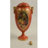 A Royal Worcester covered vase, the amber ground decorated with an oval reserve of fruit to a