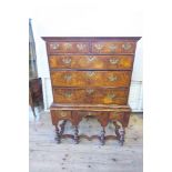 An 18th century walnut chest on stand, having two short drawers, over three long graduated long