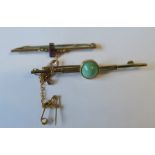 A turquoise cabochon set bar brooch, stamped '15ct', 5.2cm long, 3.2g gross, together with a paste