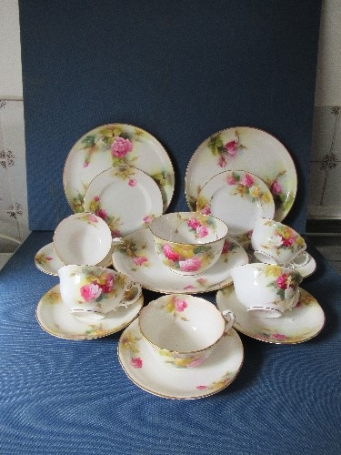 A Royal Worcester part service, decorated with roses by Spilsbury, comprising 5 cups, 4 saucers, a
