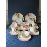 A Royal Worcester part service, decorated with roses by Spilsbury, comprising 5 cups, 4 saucers, a