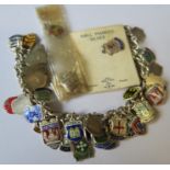 A silver bracelet, with various enamel City coat of Arms souvenir shields attached, some loose,