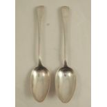 A pair of mid 18th century silver feather edge serving spoons, bottom marked, London 1761, maker