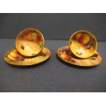 Two Royal Worcester miniature tea cups and saucers, decorated with hand painted fruit, by Hale,