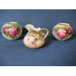 A matched pair of Royal Worcester wrythen moulded spherical vases, decorated with roses, shape G161,