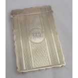 A silver card case, of shaped rectangular form, engine turned decoration and engraved with