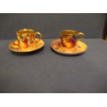Two Royal Worcester coffee cans and two different saucers, decorated with hand painted fruit by