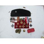 A collection of military items, to include medals, German medals, buttons, hat, etc.