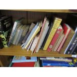 Three shelves of books and magazines