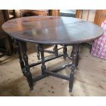 An antique oak gateleg table, fitted with a drawer, raised on turned legs, 37ins x 46ins, height