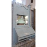 An Edwardian painted wall mirror with glove box and rail below, height 32ins, width 19ins