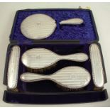 A hallmarked silver brush set, five piece, boxed