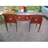 A 19th century mahogany serpentine front inlaid sideboard, fitted with drawers and cupboards,