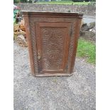 An oak corner cupboard, with carved decoration, height 43ins x width 32.5ins