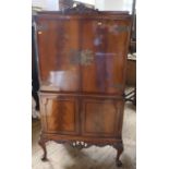 A modern mahogany drinks cabinet, the upper section having a pair of doors opening to reveal