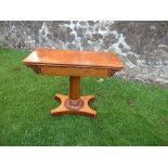 A 19th century mahogany folding top tea table, raised on a carved scrolling acanthus panelled column