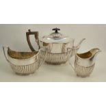 A Victorian silver three piece tea set, of oval form with gadrooned lower body, London 1887, maker