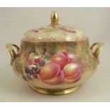 An orb porcelain circular tureen and cover, decorated with fruit to a mossy background by F Higgins,