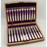 A cased silver and mother of pearl set of knives and forks, the twelve knives and forks with