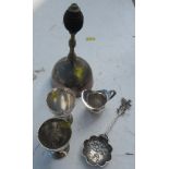 A brass bell, together with two silver plated egg cups, a silver plated miniature jug and a souvenir