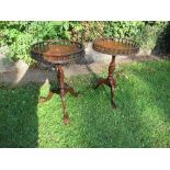 A pair of 20th century mahogany wine tables, having gallery tops and raised on a tripod base