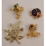 A paste and enamel comical lion brooch, together with a ladybird brooch, a paste set frog brooch,