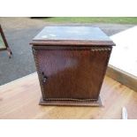 A 20th century oak smoker's cabinet, the door opening to reveal a drawer, together with various