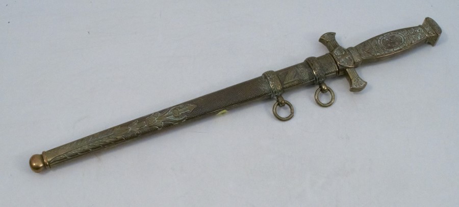 A reproduction German style dagger, with embossed brass hilt and scabbard