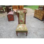 A Victorian prie dieu chair, having mahogany frame with tapestry back and seat