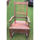 A 19th century rocking chair, with solid seat, fitted with a drawer to the side