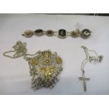 A silver cross on a chain, 2g gross, together with a silver Asian gods motif bracelet, 22g gross,