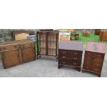 An oak sideboard, a display cabinet and two bureaus