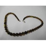 A necklace of amber beads, length 17ins