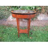 A Sheraton Revival satinwood oval bijouterie table, having hinged glazed top raised on square