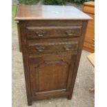 An oak cabinet, fitted with two drawers over a cupboard, 24ins x 18ins x height 42ins