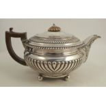A Georgian silver teapot, with gadrooned decoration, raised on ball feet, London 1815, weight 23oz